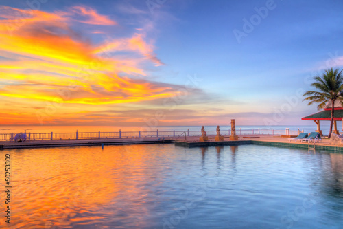 Tropical sunset at the swimming pool in Thailand