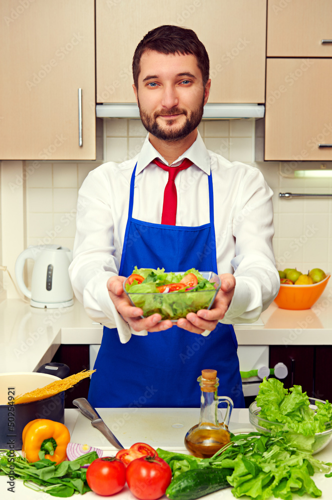 healthy man in blue apron holding salad healthy man in blue apron holding salad