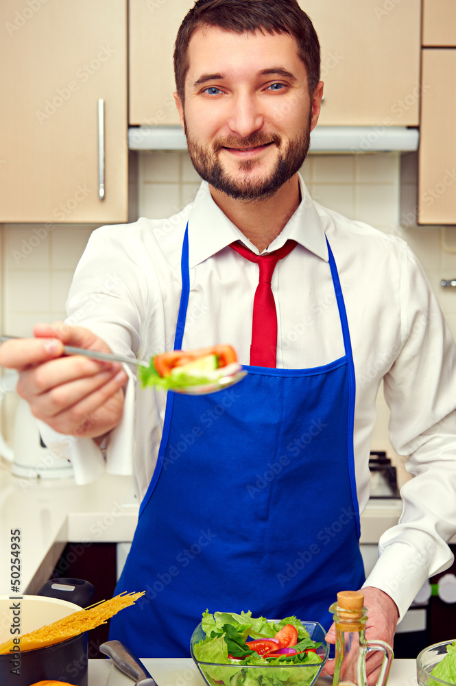 man holding spoon with salad man holding spoon with salad