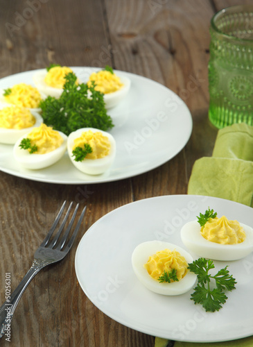 Deviled eggs with parsley in a plate