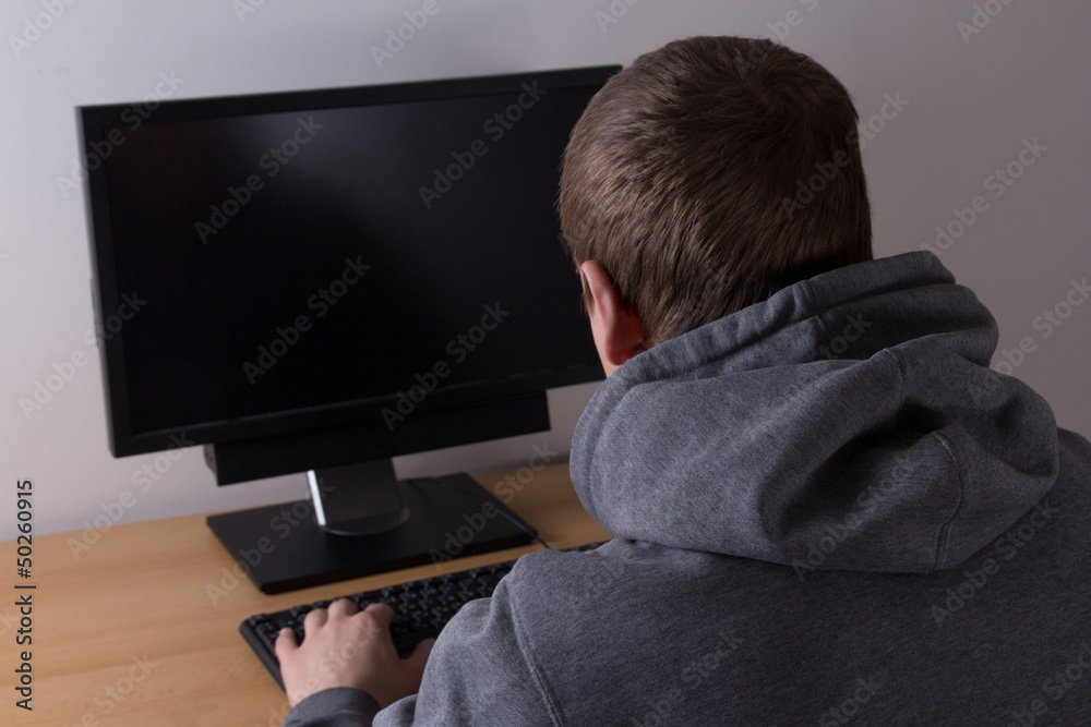 young hacker using a computer young hacker using a computer