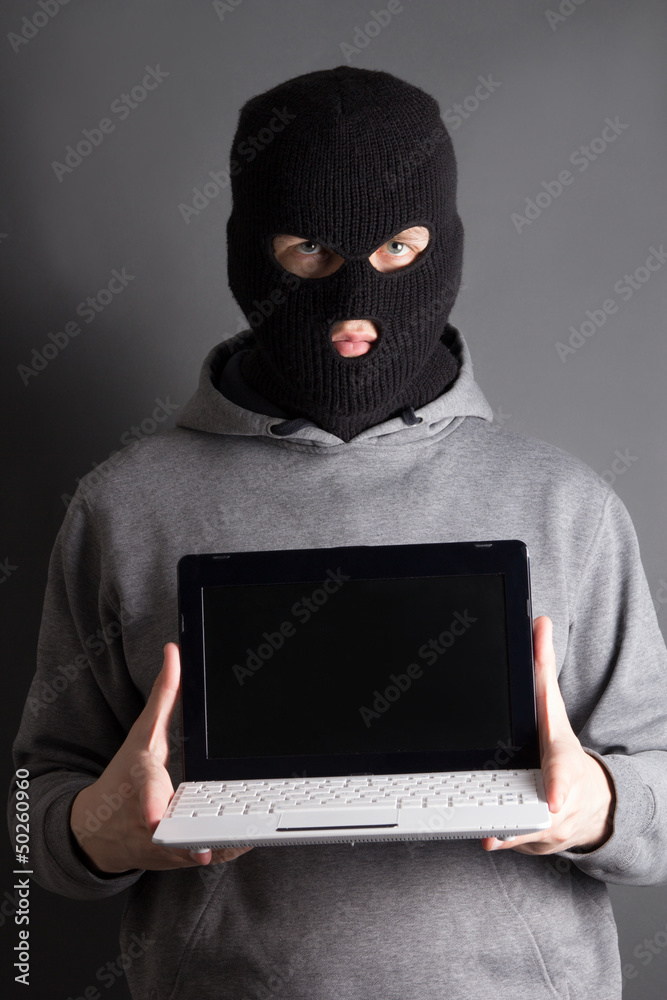 masked man with computer over grey masked man with computer over grey