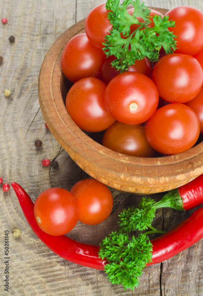 Tomato and red hot chili peppers in old mortar