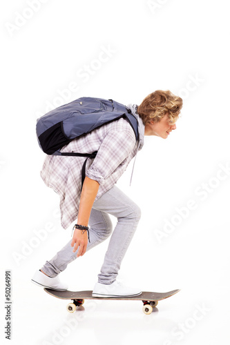 teen boy skateboarding isolated on white