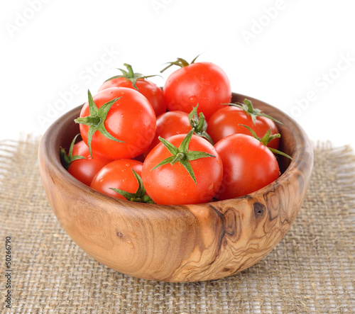 Cherry tomatoes in a bowl on a white background