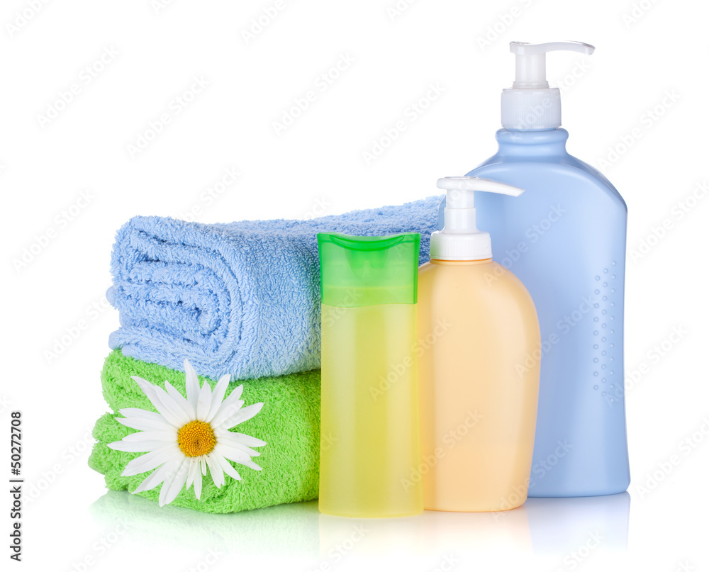 Shampoo and gel bottles with towels and flower Shampoo and gel bottles with towels and flower