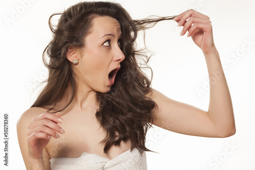shocked girl because of her damaged hair