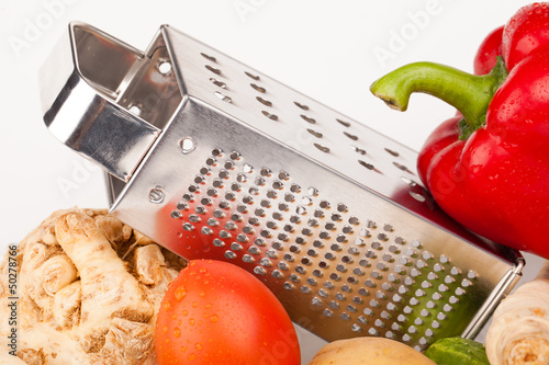 vegetables and grater isolated on white