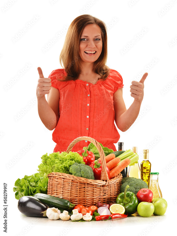 Young woman with variety of vegetables isolated on white Young woman with variety of vegetables isolated on white