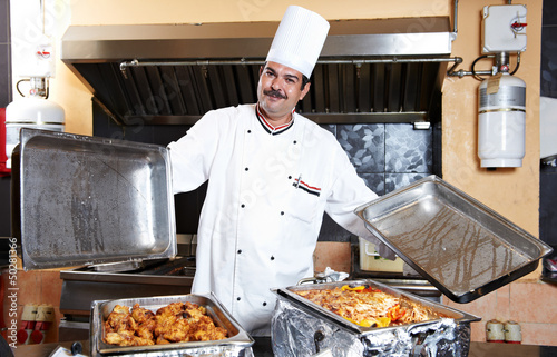 arab chef with food at restaurant hotel photo