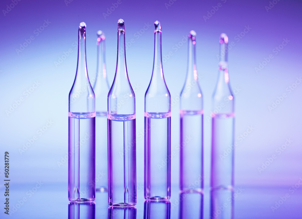 Ampules shallow depth of field macro still life on blue purple