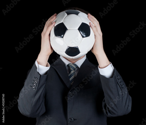 man in suit holding a soccer ball in front of his face © Vladyslav Bashutskyy