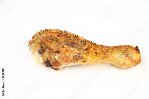Roasted chicken leg on the white plate