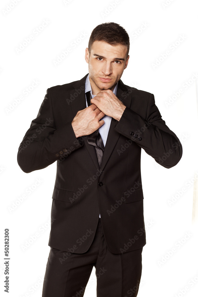 attractive businessman tied his tie before going to work attractive businessman tied his tie before going to work