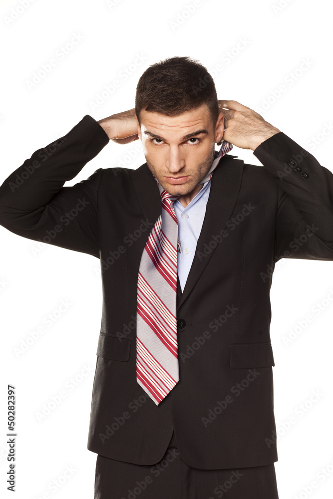 attractive businessman tied his tie before going to work attractive businessman tied his tie before going to work