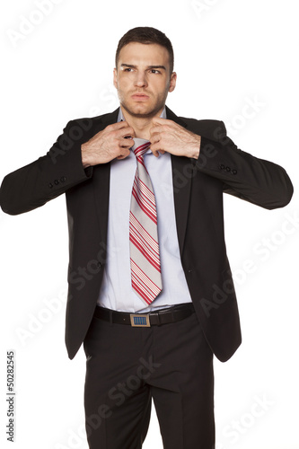 attractive businessman unfasten the tie on white background photo