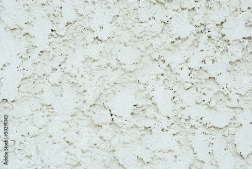 Close up on the white concrete wall texture background © PathomP