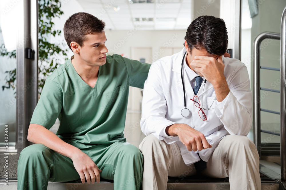 Fototapeta premium Colleague Comforting Upset Doctor