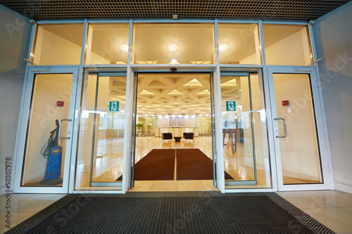 Entrance door to reception hall of office building photo