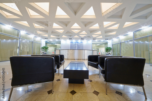 Hall with leather armchairs at business center photo