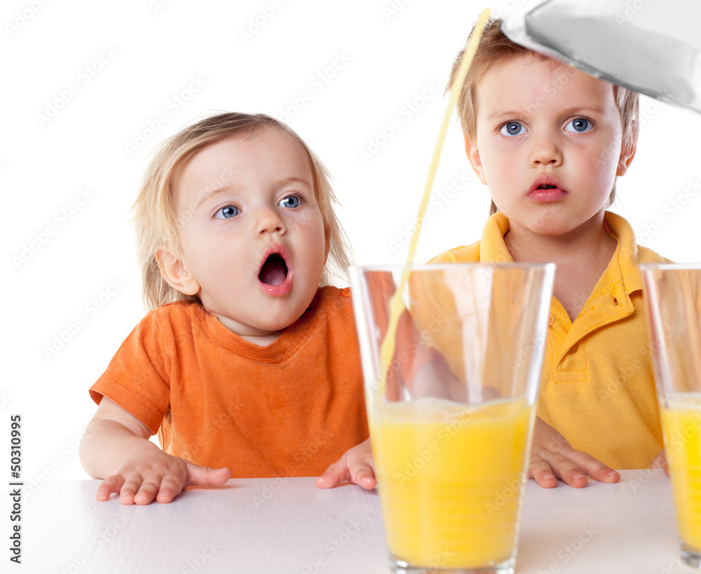 Children watch as pouring juice isolated on white Children watch as pouring juice isolated on white