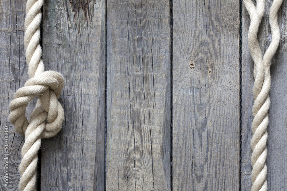 Obraz premium Rope on old vintage wooden planks abstract background