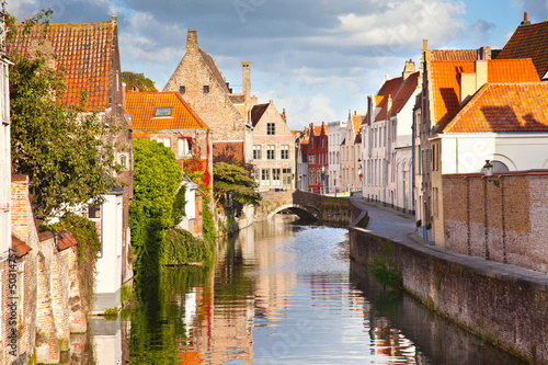Beautiful view of a canal and , bridge, red roofs in Bruges, Bel