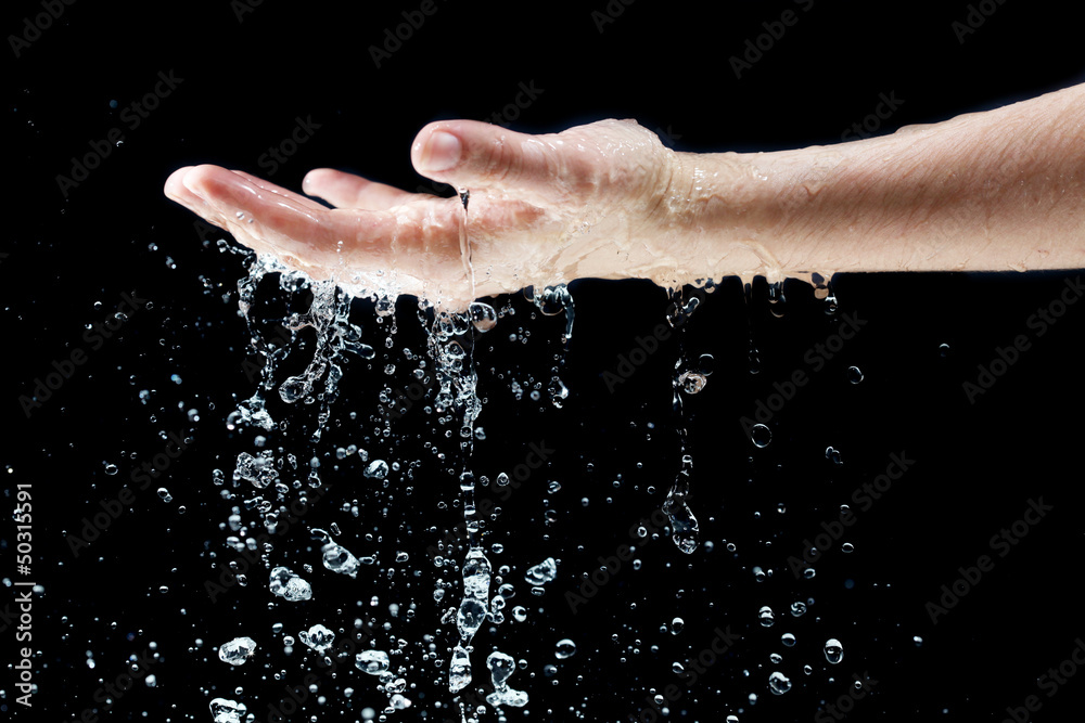 Fototapeta premium Water falling on hand