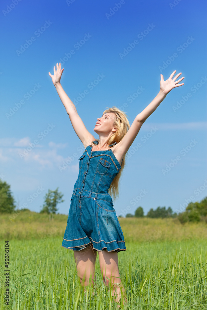 The happy young woman in the field of green ears.. The happy young woman in the field of green ears..
