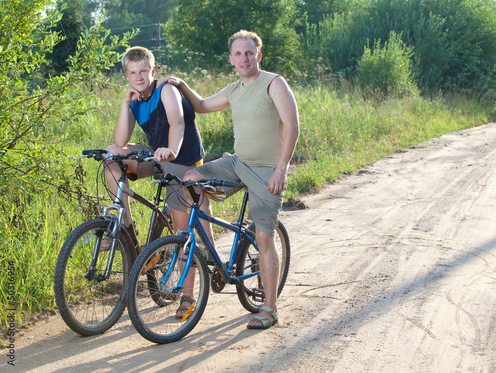 The father with the son on bicycles The father with the son on bicycles