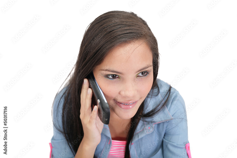 A pretty young woman talking on her cellphone A pretty young woman talking on her cellphone