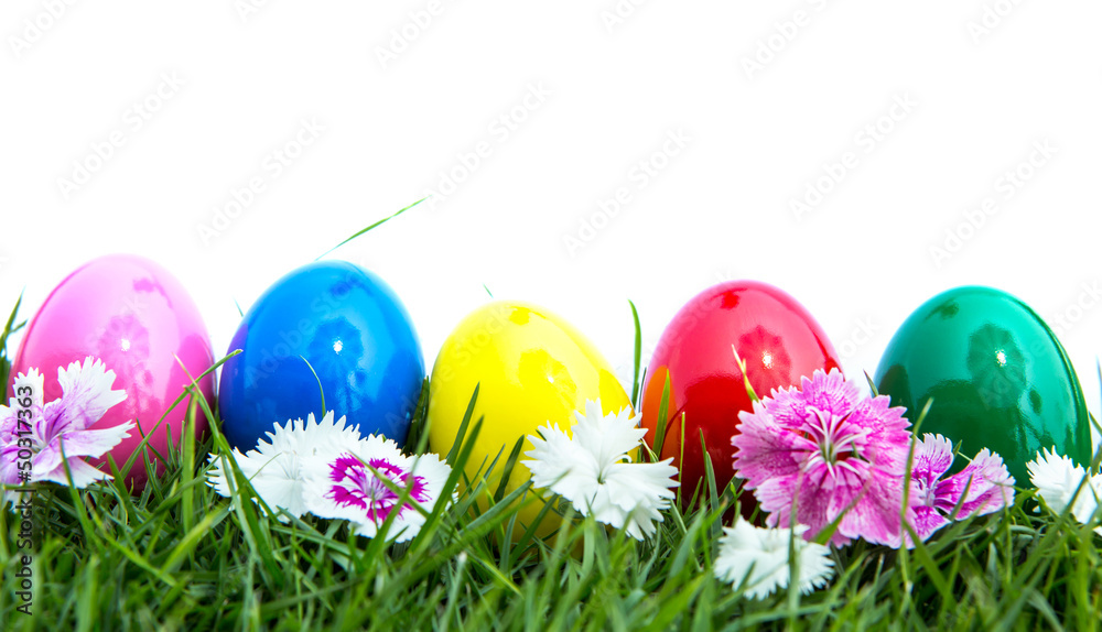 Easter eggs on green grass over white background