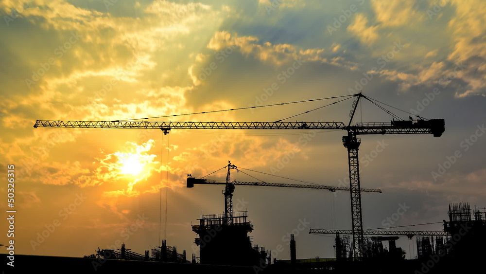time lapse sunset and silhouette crane working in site time lapse sunset and silhouette crane working in site