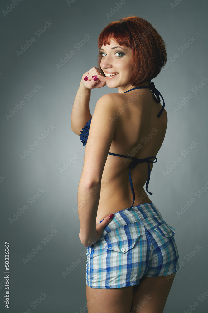 young redheaded woman in underwear isolated in a studio young redheaded woman in underwear isolated in a studio