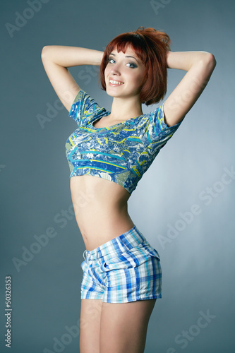 young redheaded woman in underwear isolated in a studio
