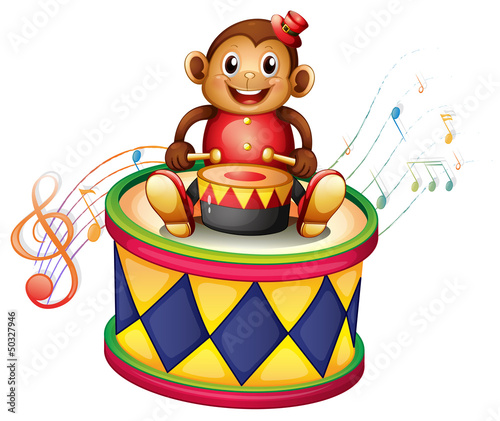 A monkey above a big drum