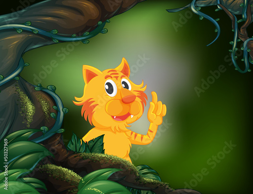 A tiger beside a big tree in the rainforest