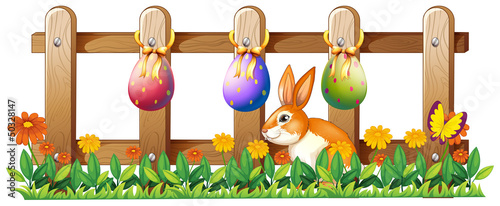 Easter eggs at the fence and a bunny