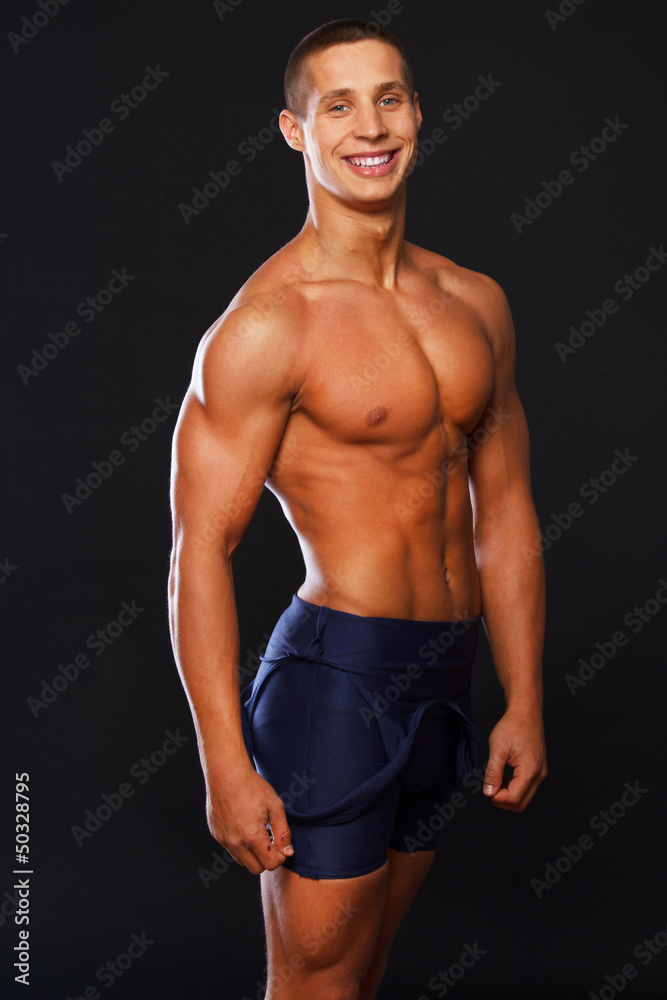 Well looking smiling man in blue shorts Well looking smiling man in blue shorts
