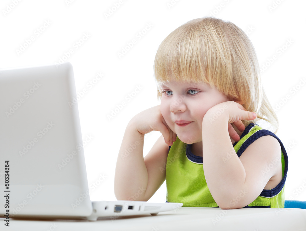 Young blonde boy looking at computer screen Young blonde boy looking at computer screen