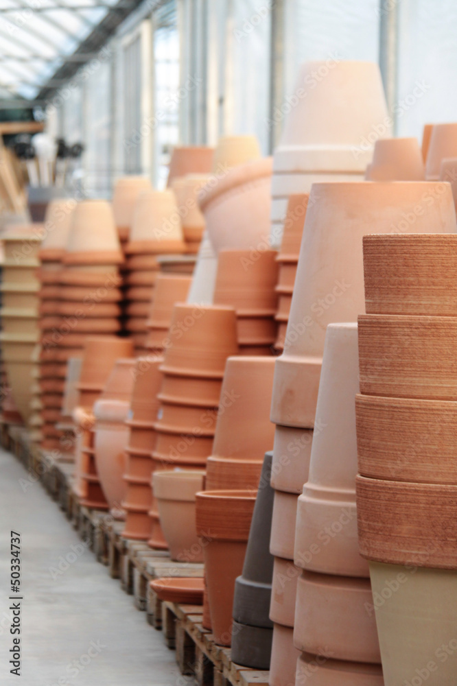 Fototapeta premium Piles of terracotta's pots in the store