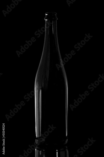 Black bottle on the black background