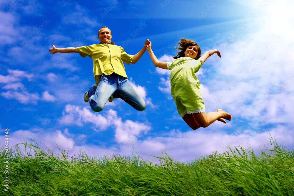 Fun couple in jump on the outdoor background Fun couple in jump on the outdoor background