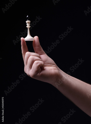 Chess in hand on a black background