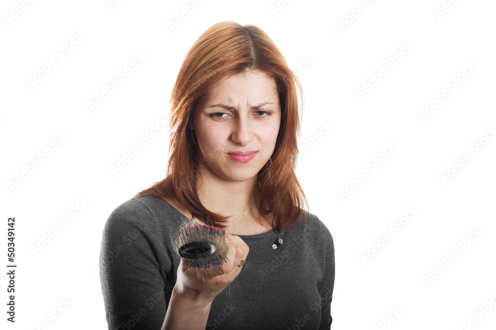 girl looks in disgust at the remaining hair on the comb girl looks in disgust at the remaining hair on the comb