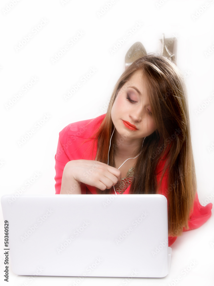 Cute girl with headphones and laptop lying Cute girl with headphones and laptop lying