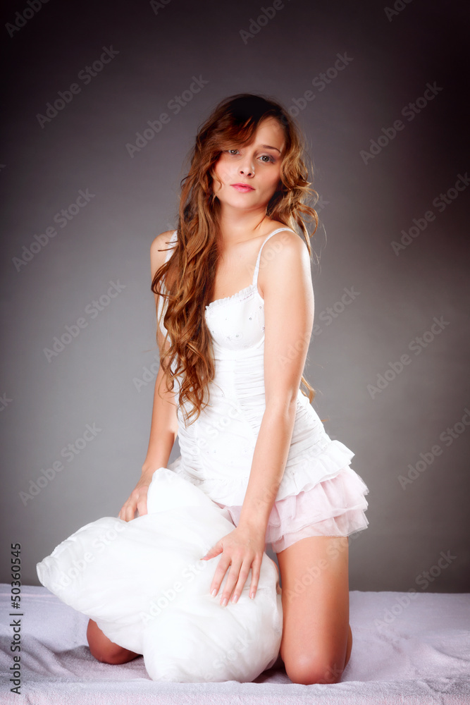 young woman with pillow in the bed young woman with pillow in the bed