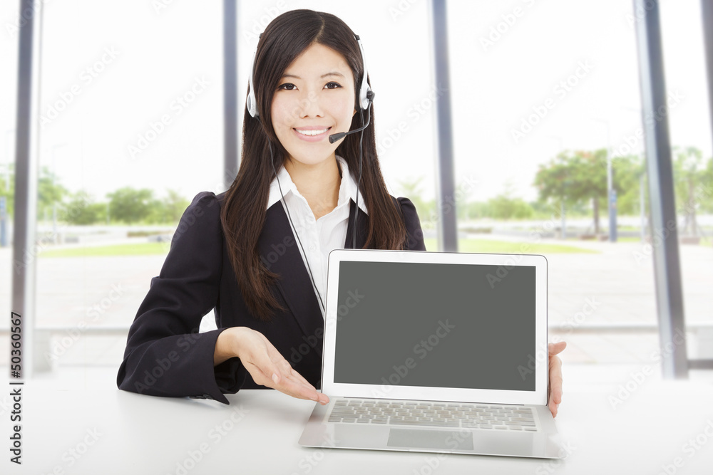 smiling businesswoman with headset and laptop in the office smiling businesswoman with headset and laptop in the office
