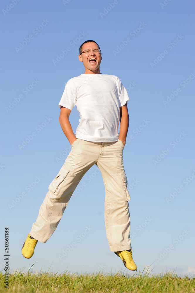 man jumping on green field