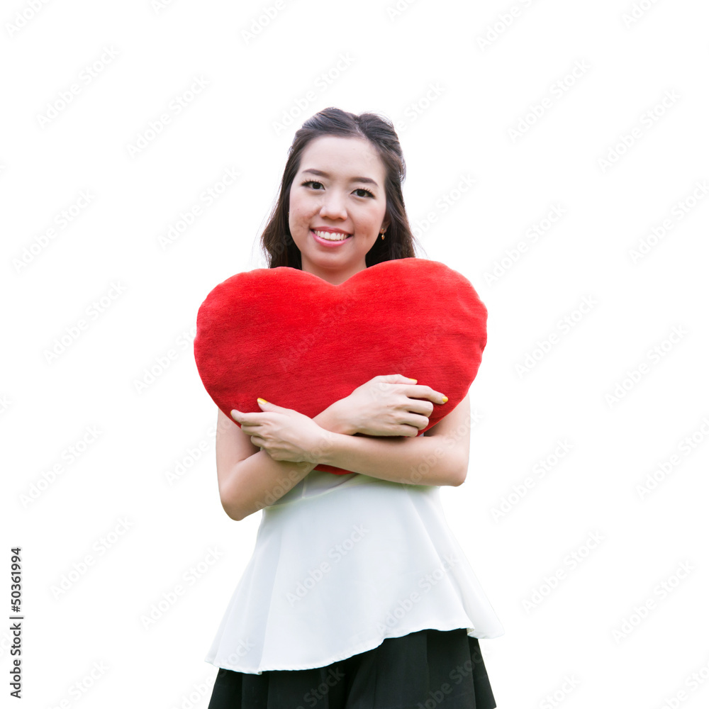 Women holding big love heart shape pillow isolated on white back Women holding big love heart shape pillow isolated on white back
